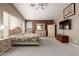 Bright main bedroom featuring neutral carpet, walls and large bed set and ceiling fan at 4531 W Flint St, Chandler, AZ 85226