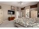 Spacious main bedroom with neutral carpet, ceiling fan, large bed set, and wall mounted television at 4531 W Flint St, Chandler, AZ 85226