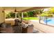 Relaxing covered patio area with comfortable seating overlooking the lush backyard and pool at 4558 E Vista Dr, Phoenix, AZ 85032