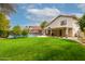 Expansive backyard featuring a well-manicured lawn and a refreshing pool with covered patio space at 4558 E Vista Dr, Phoenix, AZ 85032