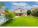 Lush backyard with a well-maintained lawn, a pool with a safety fence, and a covered patio at 4558 E Vista Dr, Phoenix, AZ 85032