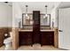 Bathroom features dual vanities with granite counters and a central cabinet for added storage at 4558 E Vista Dr, Phoenix, AZ 85032