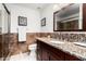 Bathroom with granite vanity, decorative mirror, and walk-in shower at 4558 E Vista Dr, Phoenix, AZ 85032