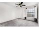 Bedroom with plantation shutters and modern ceiling fan at 4558 E Vista Dr, Phoenix, AZ 85032