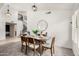 Formal dining room features a modern light fixture, neutral decor, and seating for six at 4558 E Vista Dr, Phoenix, AZ 85032