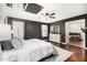 Inviting main bedroom features a ceiling fan, wood floors, ensuite bathroom, and neutral decor at 4558 E Vista Dr, Phoenix, AZ 85032