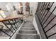 Modern staircase with black metal railings leading to an open-concept layout with kitchen and living areas at 4558 E Vista Dr, Phoenix, AZ 85032