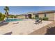 Private backyard with pool, travertine patio, green grass, and mature landscaping at 4884 S Hemet St, Gilbert, AZ 85298