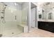 Bright bathroom with a glass walk-in shower, neutral tile floor, and dark vanity at 4884 S Hemet St, Gilbert, AZ 85298