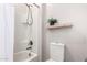 Bathroom featuring a bathtub with a showerhead and a light wood shelf at 4884 S Hemet St, Gilbert, AZ 85298