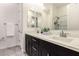 A modern bathroom featuring a double vanity with white countertops and stylish fixtures at 4884 S Hemet St, Gilbert, AZ 85298