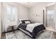 Comfortable bedroom with a ceiling fan, large windows, and hardwood floors at 4884 S Hemet St, Gilbert, AZ 85298