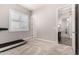 A bedroom including a treadmill and a view into an exquisitely lit neighboring room at 4884 S Hemet St, Gilbert, AZ 85298