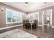 Dining room featuring natural light, hardwood floors, and a white table with seating for six at 4884 S Hemet St, Gilbert, AZ 85298