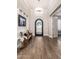 Elegant home foyer featuring hardwood floors, decorative wallpaper, and a chandelier at 4884 S Hemet St, Gilbert, AZ 85298