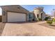 Beautiful home with a brick-paved driveway leading to a spacious garage, surrounded by manicured landscaping at 4884 S Hemet St, Gilbert, AZ 85298