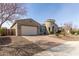 Well-maintained house featuring a spacious garage and brick-paved driveway, surrounded by desert landscaping at 4884 S Hemet St, Gilbert, AZ 85298