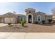 Charming home featuring a decorative front door and turret detail, complemented by low-maintenance desert landscaping at 4884 S Hemet St, Gilbert, AZ 85298