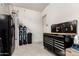A well-organized garage area featuring a workbench, tools, and water softening system at 4884 S Hemet St, Gilbert, AZ 85298