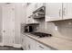 Modern kitchen featuring sleek white cabinetry, stainless steel appliances, and granite countertops at 4884 S Hemet St, Gilbert, AZ 85298
