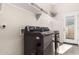 Well-lit laundry room featuring modern LG washer and dryer, with convenient shelving for storage at 4884 S Hemet St, Gilbert, AZ 85298