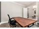 A spacious office with a solid wooden desk. The decor gives an insight to adjoining room at 4884 S Hemet St, Gilbert, AZ 85298