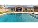 Refreshing backyard pool with baja-step, and outdoor dining area provides ample space for entertaining at 4884 S Hemet St, Gilbert, AZ 85298