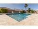 Stunning pool with travertine tile and fountain features, surrounded by lush landscaping at 4884 S Hemet St, Gilbert, AZ 85298