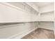 Empty walk-in closet with a carpeted floor and closet rods at 4884 S Hemet St, Gilbert, AZ 85298