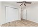 Bedroom with wood-look flooring and a double door closet with white doors at 5142 E Holly St, Phoenix, AZ 85008