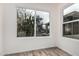 Bright bedroom features wood-look floors and a view to the outside at 5142 E Holly St, Phoenix, AZ 85008