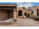 Charming stucco home featuring a covered carport and an arched entryway at 5142 E Holly St, Phoenix, AZ 85008