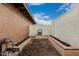 Backyard garden featuring a newly planted flower bed and a brick border at 5142 E Holly St, Phoenix, AZ 85008