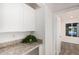 Hallway features white cabinets and a view of the pool through an open door at 5142 E Holly St, Phoenix, AZ 85008