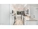 Galley kitchen with white cabinets, granite countertops, and stainless-steel appliances at 5142 E Holly St, Phoenix, AZ 85008