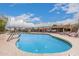 Community swimming pool with lounge chairs and a community building in the background at 5142 E Holly St, Phoenix, AZ 85008