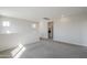 A carpeted loft with neutral walls, and view into the laundry room at 6418 N 17Th St, Phoenix, AZ 85016