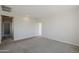 A carpeted loft with neutral walls, multiple doors, and recessed lighting at 6418 N 17Th St, Phoenix, AZ 85016