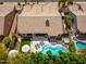 Stunning aerial view of backyard oasis featuring a sparkling pool, spa, lush landscaping, and spacious patio at 6438 E Montreal Pl, Scottsdale, AZ 85254