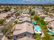 Charming neighborhood aerial view featuring tiled roofs, lush landscaping, sparkling pools, and stunning mountain views at 6438 E Montreal Pl, Scottsdale, AZ 85254