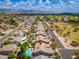 Breathtaking aerial view of neighborhood showcasing landscaped yards, swimming pools, nearby golf course, and mountain views at 6438 E Montreal Pl, Scottsdale, AZ 85254