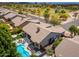 Incredible aerial view showcasing a backyard pool, patio, spa, and lush landscaping in a lovely neighborhood at 6438 E Montreal Pl, Scottsdale, AZ 85254