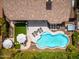 Amazing aerial view of private backyard with pool, spa, sun loungers, patio area, and lush landscaping at 6438 E Montreal Pl, Scottsdale, AZ 85254