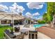 Inviting backyard with a pool, outdoor seating, and lush greenery creating a perfect space for relaxation and entertainment at 6438 E Montreal Pl, Scottsdale, AZ 85254