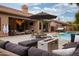 Spacious backyard with a pool, spa, fire pit, and comfortable seating areas at 6438 E Montreal Pl, Scottsdale, AZ 85254