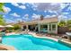 Backyard showcasing a refreshing pool, patio seating, lush landscaping, and seamless indoor-outdoor living at 6438 E Montreal Pl, Scottsdale, AZ 85254