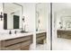 Bathroom with a mirrored wall, modern vanity, and tiled flooring that complements the design creating an open feel at 6438 E Montreal Pl, Scottsdale, AZ 85254