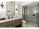 Modern bathroom with a dual-light vanity and a glass-enclosed walk-in shower at 6438 E Montreal Pl, Scottsdale, AZ 85254
