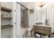 Bathroom with tiled shower over tub, floating shelves, and patterned flooring at 6438 E Montreal Pl, Scottsdale, AZ 85254