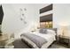 A modern bedroom features a large window, gray accents, and stylish decor at 6438 E Montreal Pl, Scottsdale, AZ 85254